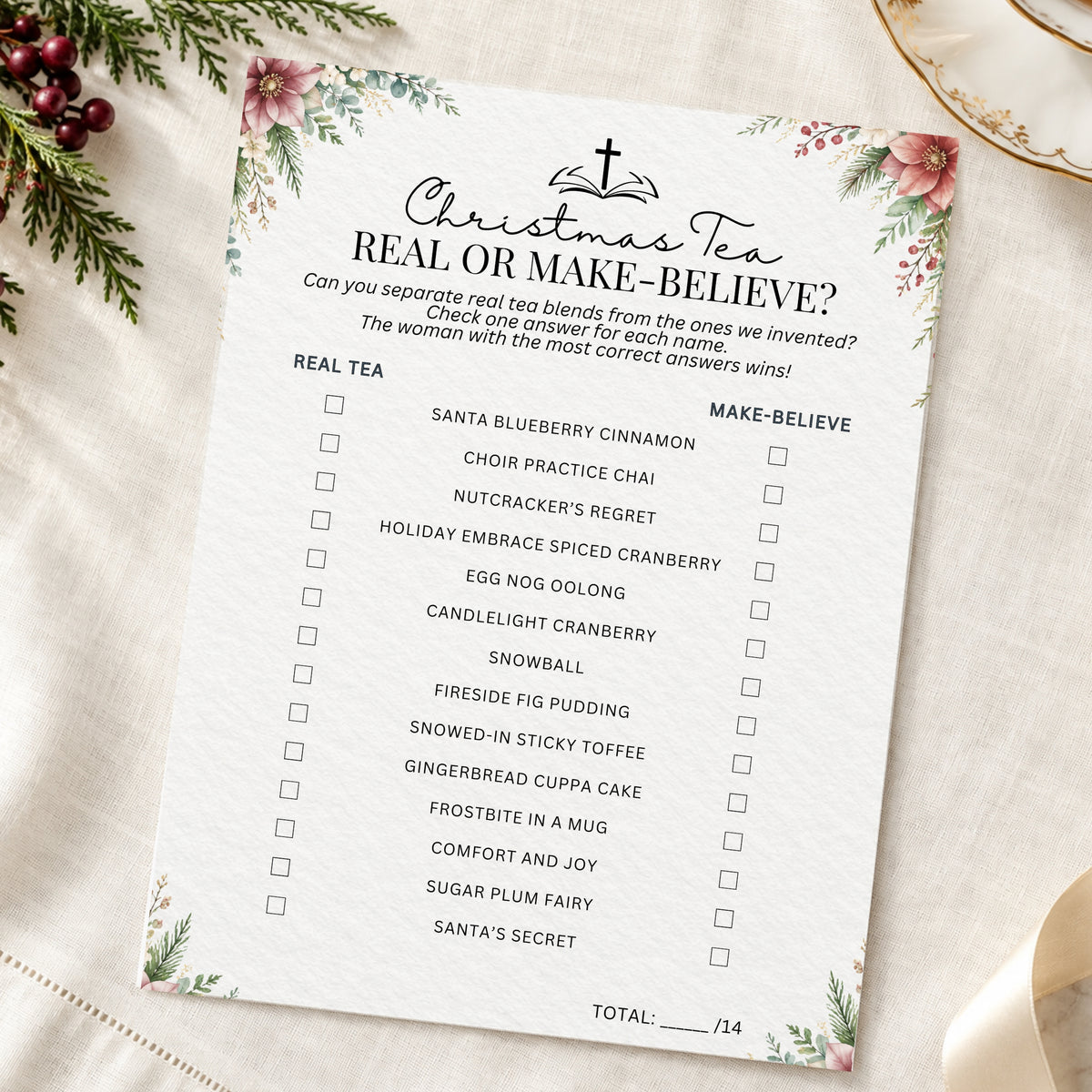 A printed Christmas-themed party game sheet titled "Christmas Tea: Real or Make-Believe?" with a list of tea flavors and checkboxes, styled on a cream fabric background with floral corner decorations and holiday greenery.